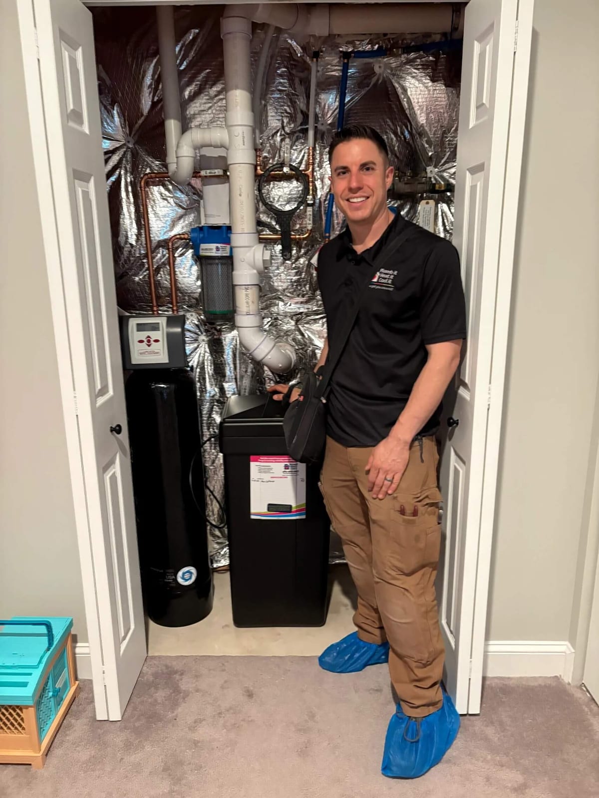 Licensed plumber performing water treatment service